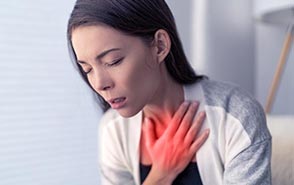 women feeling chest pain